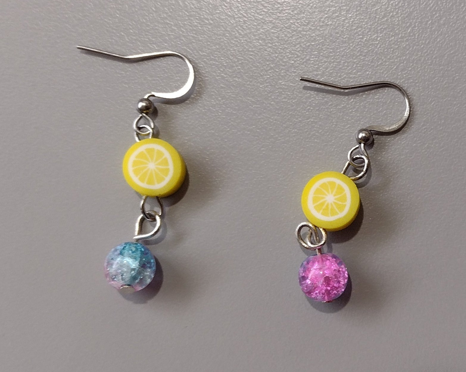 Lemon Drop Earrings with a lemon slice made of Polymer clay and a multi colored glass bead.