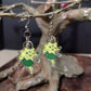 Front side of the Green Larcunight earrings showing the designee.